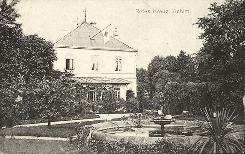 Achim (Verden). Rotes Kreuz mit Parkanlage und Springbrunnen