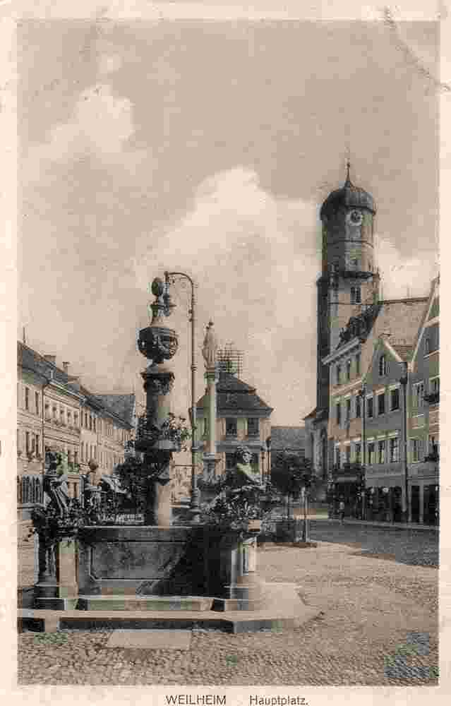 Weilheim in Oberbayern. Marienplatz, St Mariä Himmelfahrt Kirche, Brunnen